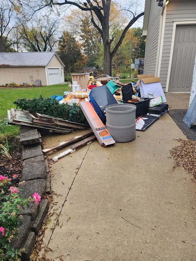 Dumpster being loaded with debris for 10 Yard Dumpster Rental in Randolph